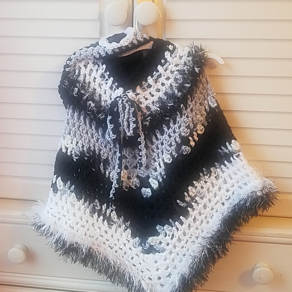 Handmade poncho and matching hat set .